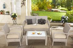 an outdoor patio furniture set with cushions and pillows