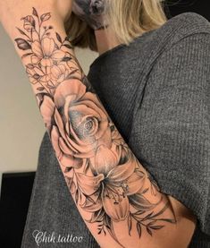 a woman with a flower tattoo on her arm