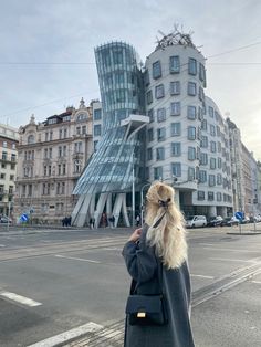 a person with a long white hair and beard standing in front of a large building