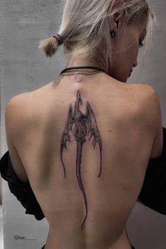 a woman with a tattoo on her back