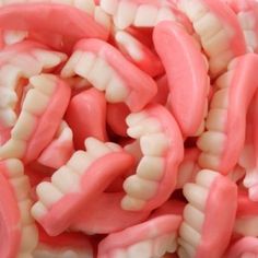 close up view of gummy teeth in pink and white