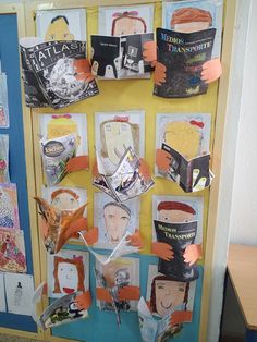 a bulletin board with books on it and paper cutouts in the shape of people's faces