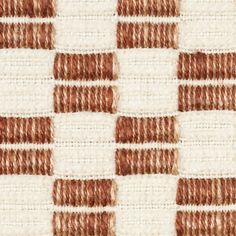 a close up view of an area rug with brown and white squares