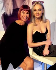 two women sitting next to each other on a chair