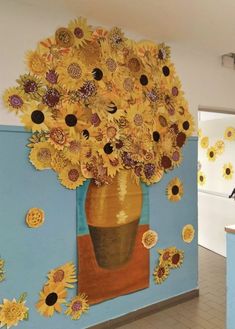 there is a vase with sunflowers on the wall