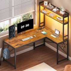 a computer desk with a monitor and keyboard sitting on top of it next to a window