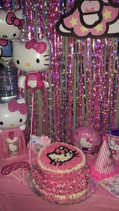 a hello kitty themed birthday party with cake and decorations