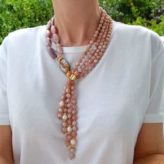 Sunstone, rodocrosita and pearl layered necklace. Chunky statement natural gemstone beaded necklace for women. Large white beige handmade necklace with big bead and gemstone. Big bold bohemian bright necklace in gold color are suitable for an casual look, evening look and for a holiday. These necklace will be a good Christmas, anniversary, wedding or birthday gift for women, mom, wife, girlfriend, sister or daughter. Women's necklace with natural stone. It emphasizes the beauty of your neck and Statement Necklace 2024, Elegant Multi-strand Beaded Necklaces With Gemstones, Elegant Multi-strand Gemstone Beaded Necklace, Elegant Double Strand Long Necklace With Natural Stones, Elegant Multi-strand Gemstone Beaded Necklaces, Elegant Handmade Double Strand Beaded Necklace, Elegant Handmade Lariat Beaded Necklace, Multi-strand Pearl Necklace With Natural Stones For Gifts, Gift Multi-strand Pearl Necklace With Natural Stones