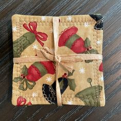 a small piece of cloth with a bow tied to it on top of a wooden table