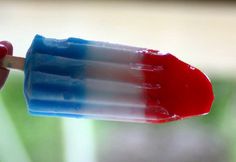 a popsicle with red, white and blue icing on it