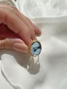 Introducing a graceful Mother & Child ring! Featuring a beautiful, elegant blue agate cameo ring framed by a textured golden silver sterling. Ring is easily adjustable to fit any adult size. The silver band is completely irritation and allergy free, silver sterling 925.  Perfect gift for mothers day, anniversary, bridal jewelry, wedding jewelry. *part of a matching set! checkout the necklace section in our shop <3 Agate is a variety of banded Chalcedony, which is a variety of the mineral Quartz, known for helping you express yourself freely. No cameo is the same,  each piece is unique. Design: lady surrounded by long hair, gazing romanticly.  Size of silver band: adjustable for all adult sizes.  Size of cameo: 1.7 cm X 1.2 cm Enjoy a wide collection of seashell and agate cameos in our shop Cameo Rings As Gift In Fine Jewelry Style, Elegant Cabochon Signet Ring As Gift, Elegant Cameo Signet Ring For Anniversary, Classic Cameo Rings As A Gift, Fine Jewelry Cameo Rings For Weddings, Classic Cameo Rings As Gift, Yellow Gold Cameo Signet Ring As Gift, Yellow Gold Cameo Rings For Gifts, Elegant Wedding Cameo Signet Ring