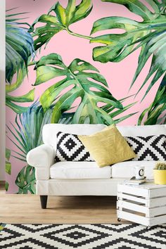 a living room with a white couch and pink wallpaper that has green leaves on it