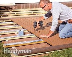 a man is working on some wood planks