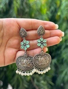 These light weight oxidised earrings are the perfect everyday accessory for both western and traditional outfits. The silver of the earrings is made more beautiful by the coloured stones - available in light pink, dark pink and mint green.  In case of any queries, please feel free to contact us. Happy shopping! Fusion Green Jhumkas For Wedding, Heavy Green Drop Jhumkas, Ambi Design, Green Dangle Jhumkas For Gift, Festive Green Bohemian Jhumkas, Green Intricate Fusion Jhumkas, Silver Jhumkas, Junk Jewellery, Oxidised Earrings