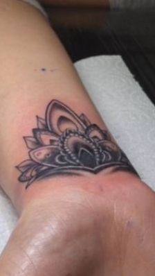 a woman's foot with a tattoo on it and a flower in the middle