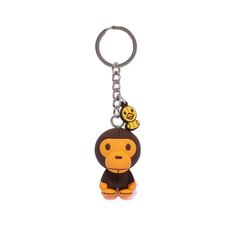 a monkey keychain with a smiley face on it