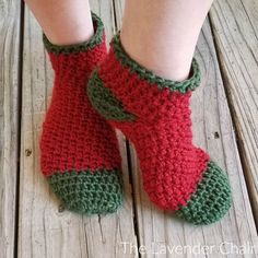 the legs of a person wearing red and green crocheted socks