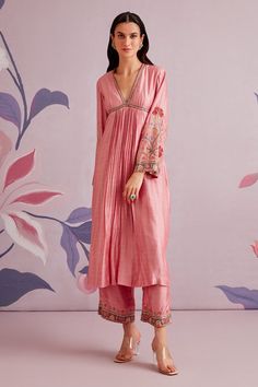 Pink kurta on silk base with front pleats and floral embroidered sleeves. Paired with pant with embroidered hem.
Component: 2
Pattern: Embroidered
Type Of Work: Floral Motifs
Neckline: V-neck
Sleeve Type: Flared
Fabric: Silk
Color: Pink
Other Details: 
Floral embroidery
Front and back pleats
Occasion: Puja - Aza Fashions Silk Kurtas, Ridhi Mehra, Pink Kurta, Silk Pant, Straight Fit Pants, Silk Kurta, Embroidered Pants, Kurta With Pants, Kurta Set