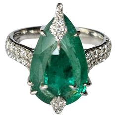 an emerald and diamond ring set in white gold