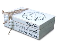 three wooden boxes tied with twine and white bead, each holding a message