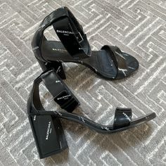 Balenciaga Black Leather With Balenciaga Logo All Over. 80mm Heel Height. Size 36.5 Very Good Condition- Worn Twice Lightly. No Scuffs Or Scratches. No Box Just Dust Bag Can Be Provided. Shoes Balenciaga, Balenciaga Logo, Balenciaga Black, Balenciaga Shoes, Heel Sandal, Block Heels Sandal, Women's Shoes Sandals, Block Heels, Balenciaga