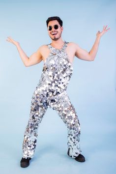 Our new Silver Sequin Jumpsuit. Each sequin is hand-sewn onto a quality base material, providing all out glamour and comfort. In True Studio 54 style, we love this fabulous disco jumpsuit. Unique to Lady Jane Sequins, we make each jumpsuit to fit to size. So please allow 2-4 weeks for making and posting, if you need it quicker drop us a message. We can make a jumpsuit for you in any sequin colour at no extra cost, so if you can't see your favourite colour here, just drop us an email.  Please inc Metallic Sequined Jumpsuits And Rompers For Party Season, Glamorous Metallic Jumpsuits And Rompers With Sequins, Glamorous Metallic Jumpsuit With Sequins, Sequin Jumpsuits For Costume Party, Sequined Jumpsuits For Costume Parties, Sequin Jumpsuits And Rompers For Costume Party, Fitted Sequin Disco Jumpsuits And Rompers, Fitted Disco Jumpsuits And Rompers With Sequins, Silver Sequined Jumpsuit For Party Season