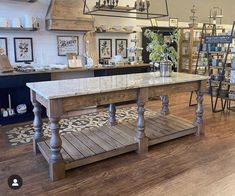 a room filled with lots of tables and chairs in front of a store display case