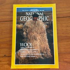 the front cover of national geophic magazine on a wooden table with wood flooring