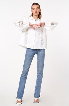 This classic cotton shirt is sweetly updated with lacy accents and charming circle trim. 24 1/2" length Front button closure Spread collar Long sleeves with button cuffs 100% cotton Hand wash, dry flat Imported Asian & Pacific Islander Owned/Founded Cotton Eyelet Blouse With Relaxed Fit, Spring Lace Trim Button-up Shirt, Casual Broderie Anglaise Shirt For Spring, Spring Button-up Top With Lace Cuffs, Classic Shirt With Lace Collar For Spring, Spring Lace Collar Button-up Shirt, Feminine Cotton Shirt With Button Closure, Classic Button-up Shirt With Lace Trim, Spring Collared Shirt With Lace Trim