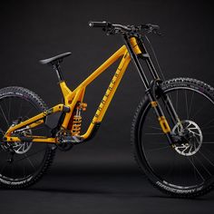 a yellow and black mountain bike against a dark background