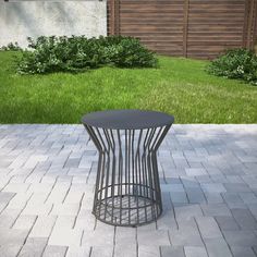 a metal table sitting on top of a brick patio