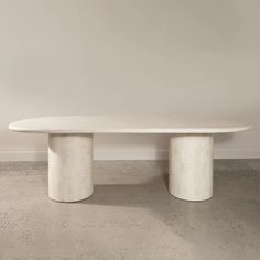 a white table sitting on top of a cement floor