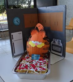 a cake in the shape of a tiger sitting on top of a pan