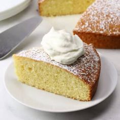 a piece of cake on a plate with whipped cream