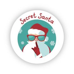 a button with a santa clause on it and the words secret santa written in red