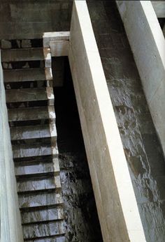 stairs going up to the top of a concrete structure with water running down them and on either side