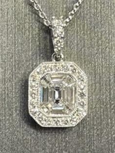 LADIES 14KT WHITE GOLD DIAMOND PENDANT One Of The Finest Quality Money Can Buy This Pendant Consists of One 1/4ct Emerald Cut Diamond Surrounded By 8 Fancy Tapered Baguette Diamonds And Accented With Another 24 Round Diamonds Talk About Sparkle! This Lovely Is Matched With A 14KT White Gold Solid Link 18" Chain Total Gold Weight = 3.1 Grams Claw Lock Closure Our Price $1195.00  Regularly Priced At $2200.00  Please See Our Video  Remember - whether you're purchasing for yourself or a gift for a l Baguette Diamonds, Emerald Cut Diamond, Emerald Cut Diamonds, Baguette Diamond, Emerald Cut, White Gold Diamonds, Diamond Pendant, Round Diamonds, Gold Diamond