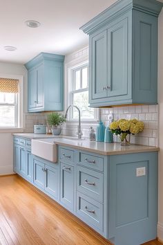 a kitchen with blue cabinets and wooden floors