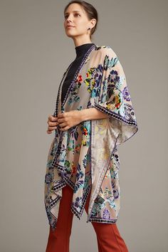 Our Velvet Muse Burnout Ruana is a stunning piece that showcases a beautiful floral design. The floral elements are of varying sizes and were delicately arranged across the fabric, creating a captivating tapestry that exudes serene beauty. The kimono also features a unique border with charming polka dots for a playful touch to its sophisticated design. Wrapped in this luxurious velvet kimono, you will enjoy unparalleled comfort and glamour. The soft, plush velvet fabric feels lovely against your Festive Floral Print Kimono, Bohemian Floral Print Dupatta For Festive Occasions, Traditional Floral Print Dupatta For Spring, Multicolor Floral Embroidered Festival Shawl, Multicolor Floral Embroidered Shawl For Festival, Bohemian Floral Print Shawl For Summer, Elegant Floral Print Dupatta, Spring Festive Multicolor Dupatta, Multicolor Kimono With Floral Embroidery