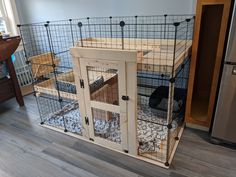 a cat house made out of wood and wire