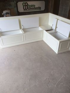 three white benches sitting next to each other in a room