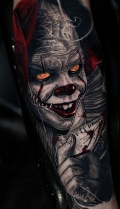 a tattoo with a creepy clown holding a knife and looking at something in his hand