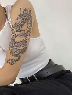 a woman with a dragon tattoo on her arm