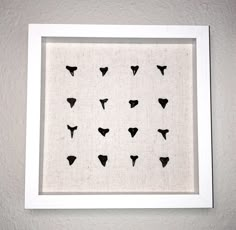 a black and white framed art piece on the wall