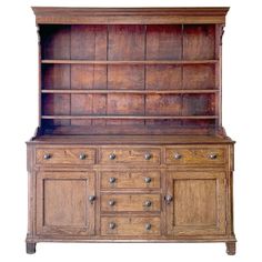 an old wooden dresser with drawers and cupboards