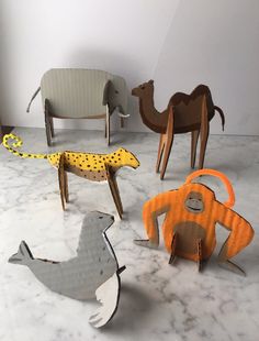 various wooden animals and giraffes are on the floor