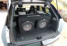 the back end of a car with two speakers in it