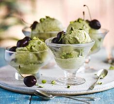 three small bowls filled with ice cream and cherries