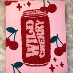 a cake made to look like a can of soda with cherries on the side