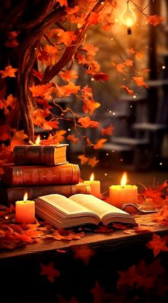 an open book sitting on top of a wooden table next to some candles and leaves